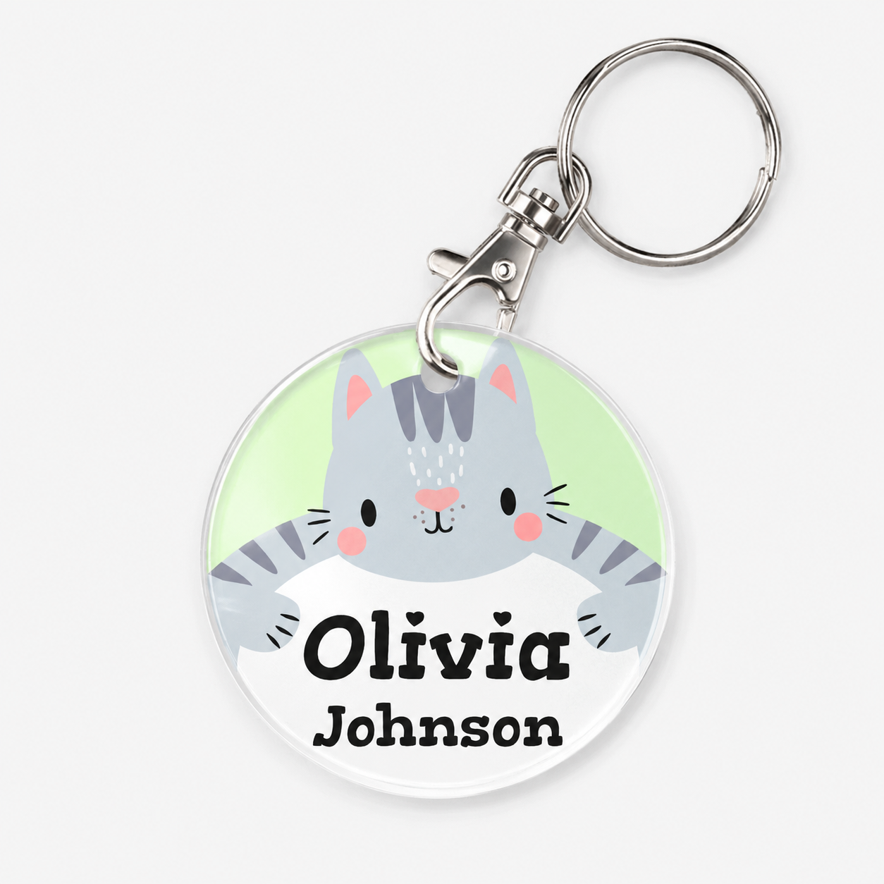 A personalized acrylic bag tag featuring a cat and example text 'Olivia Johnson'. 