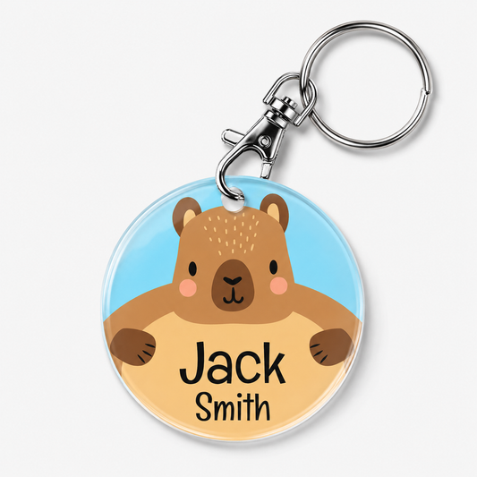 A personalized acrylic bag tag featuring a capybara and example text 'Jack Smith'. 