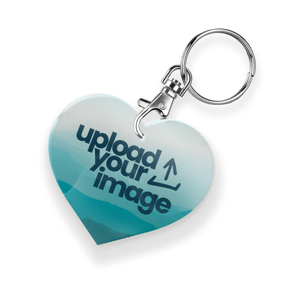 A personalised keyring featuring a heart photo frame design with a metal keychain and clasp. The photo a cyan mountain background overlaid with an 'Upload your Image' icon. 