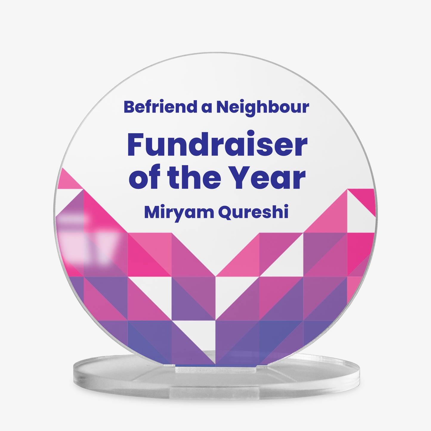A round acrylic display plaque on a clear base. The design features three lines of customisable placeholder text reading 'Your Text Here' in bold blue font. The lower half is decorated with a vibrant geometric pattern made of colourful triangles in varying shades of purple, arranged in a symmetrical chevron shape.