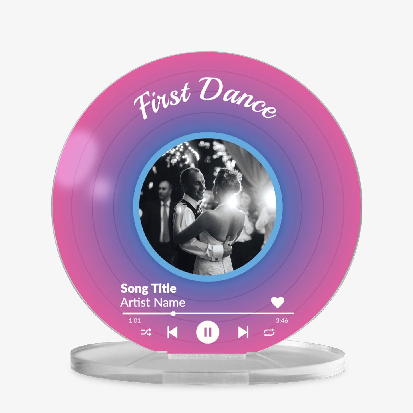 Acrylic custom vinyl record-style display with a pink and purple gradient background with a circular photo in the centre, personalised text 'First Dance' at the top, and a mock music player interface showing song title and artist name at the bottom.