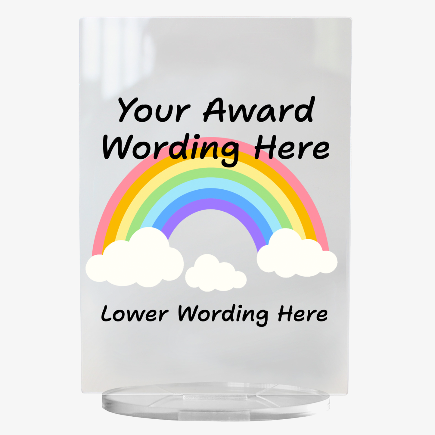 A clear acrylic award plaque standing on a circular base, featuring a large rainbow with either end in a cloud in the centre. Overlaying the rainbow is placeholder text reading 'Your Award Wording Here' in bold black font. Below, additional text reads 'Lower Wording Here'. 