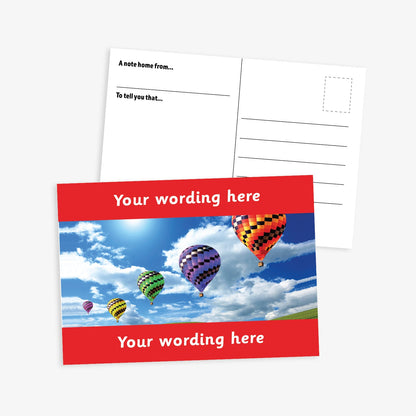 Personalised A6 Hot Air Balloon Postcard, featuring a red border framing a sky scene with multiple colourful hot air balloons floating among clouds. The front side includes the placeholder text 'Your wording here!' in bold white letters, allowing for customisation. The reverse side displays a standard postcard layout with space for a message and address.