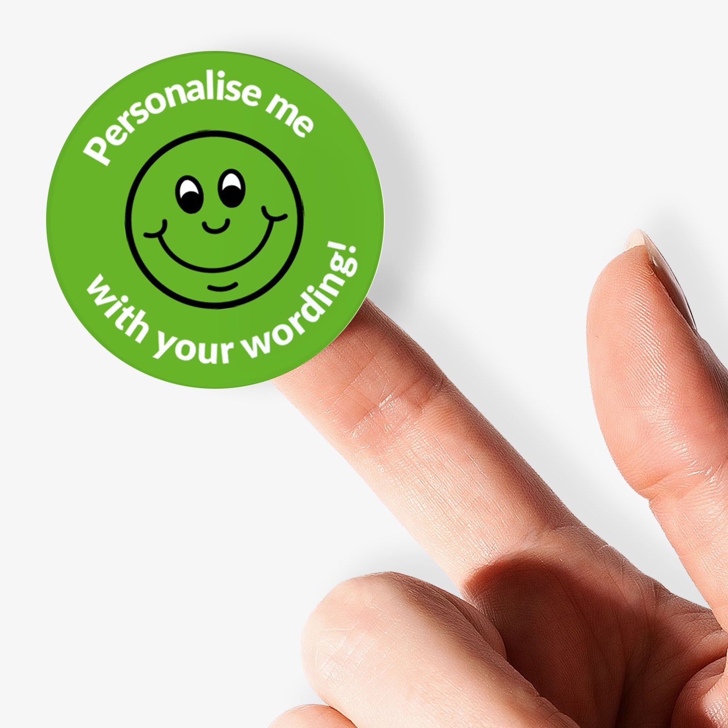 Green sticker, on a finger, with a smiling emoji as the central image.  Space for personalisation above and below the image.
