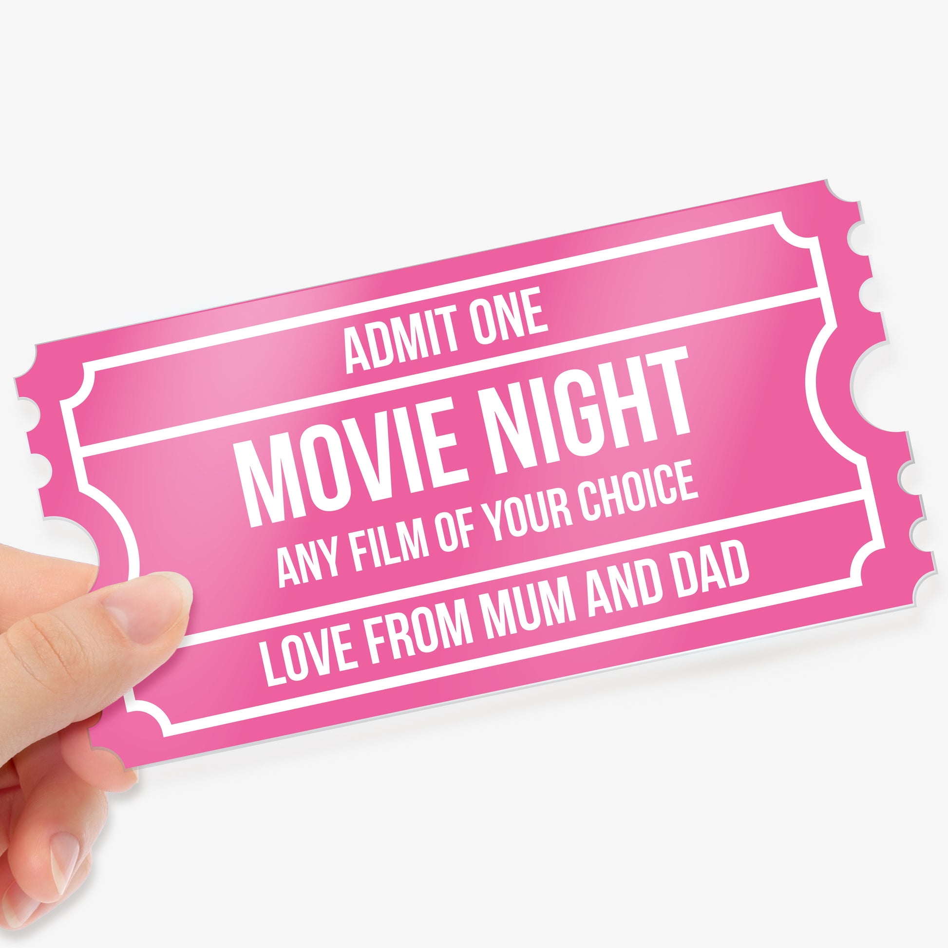 Hand holding a pink acrylic event ticket with customisable text fields completed to say, including 'ADMIT ONE', 'MOVIE NIGHT', 'ANY FILM OF YOUR CHOICE', and 'LOVE FROM MUM AND DAD', designed with a classic ticket border style.
