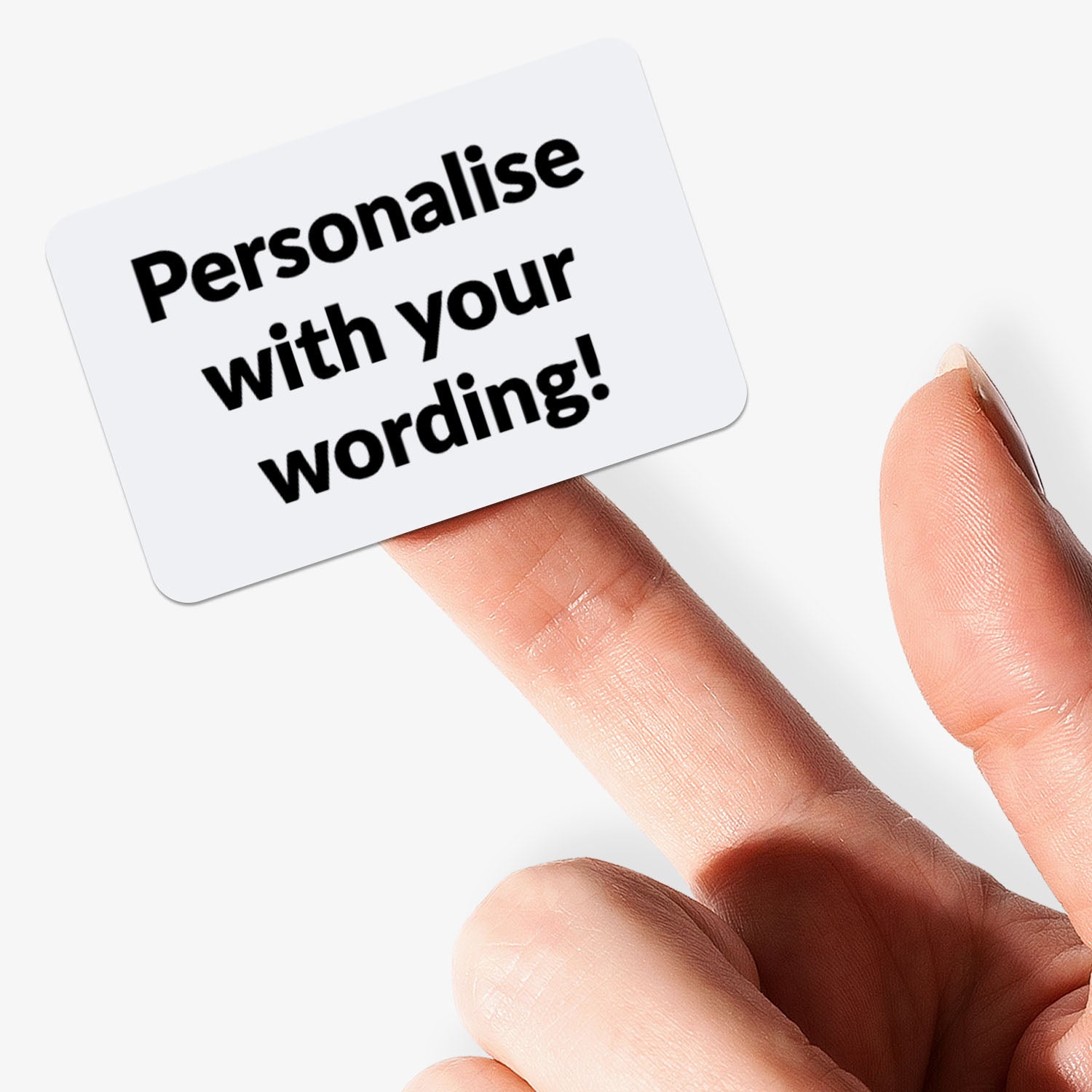 Customizable sticker with black text and white background held by a hand.