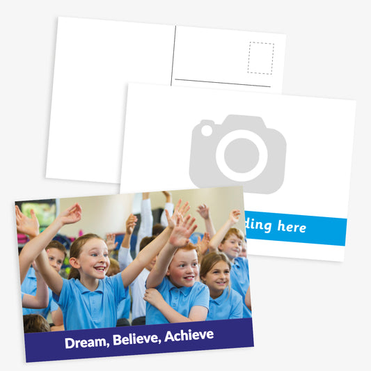 Customisable school postcard design. The front shows a group of smiling primary school children in blue uniforms raising their hands, with a caption at the bottom reading 'Dream, Believe, Achieve'. The one below includes space for a photo and banner at bottom for customised text.  The reverse of the postcard has space for a message, address, and stamp.