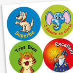 A sheet of colourful reward stickers for children, each with a cartoon character and French text. This includes: a happy dog on a blue background with the word 'Superbe', a smiling elephant on a green background with 'J'écoute en classe', a cheerful tiger on a green background with 'Très Bien' and  a wizard casting stars on a red background with 'Excellent'.