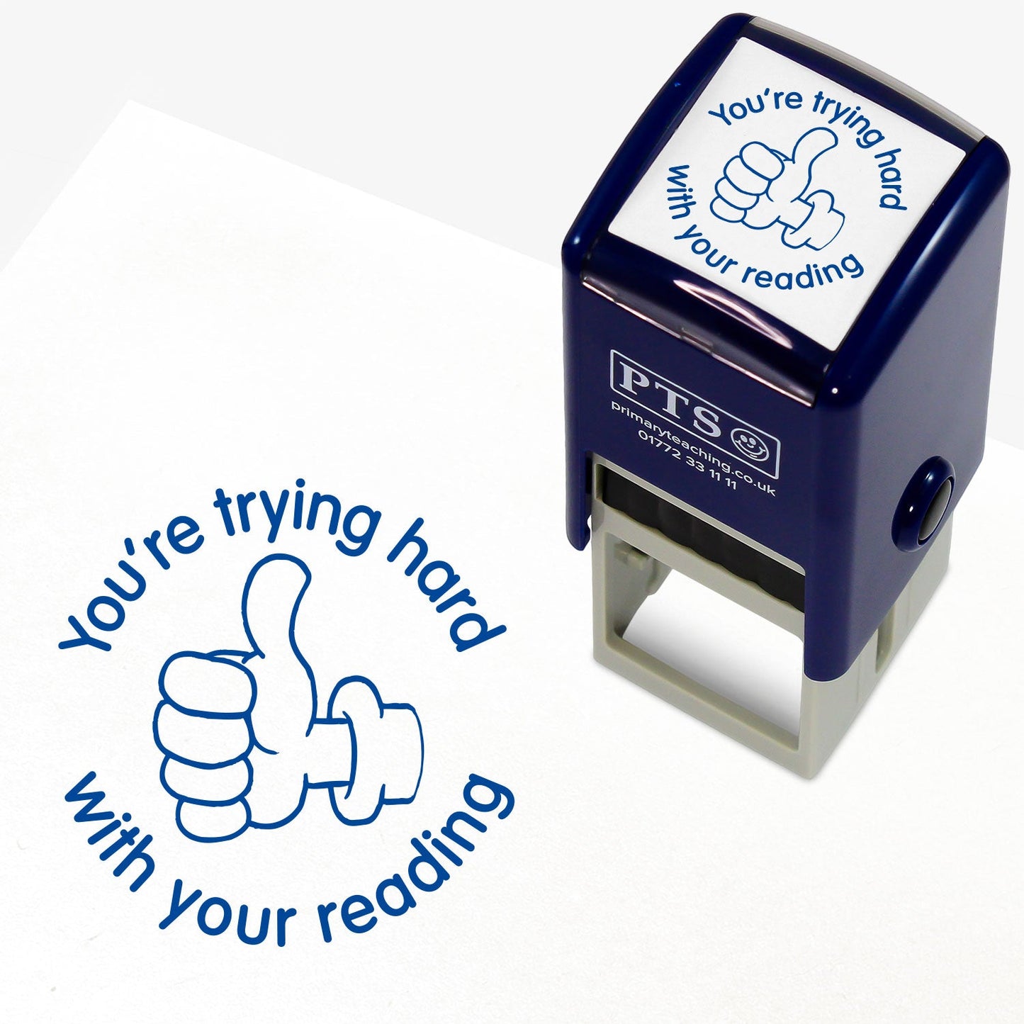 Blue 25mm pre-inked stamper featuring a thumbs up icon surrounded by the phrase 'You're trying hard with your reading'.