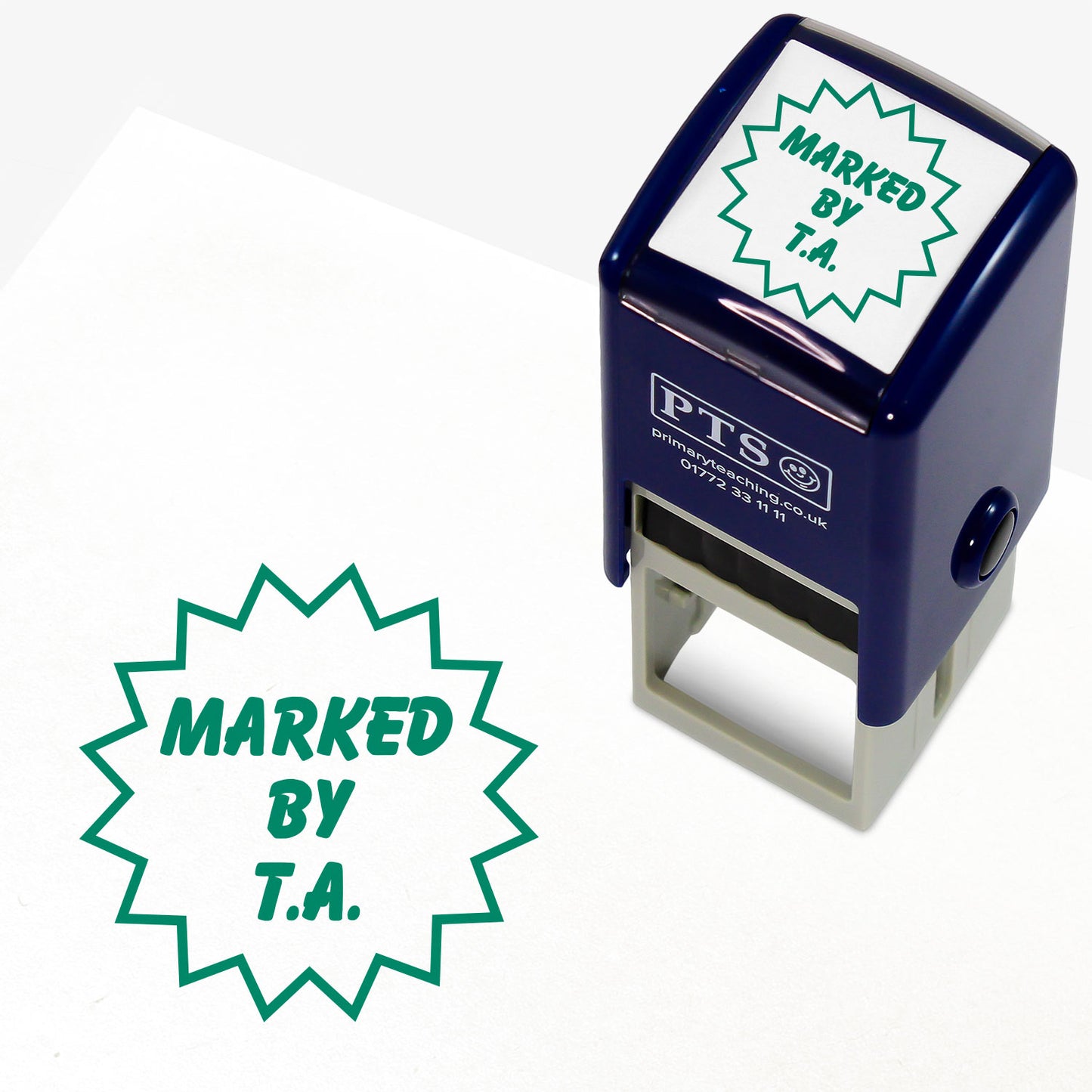 A 25mm self inking stamper with green ink with the phrase 'MARKED BY T.A.' within a flash