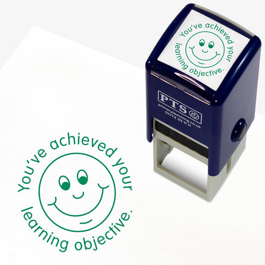 Green 25mm pre-inked stamper featuring a smiling face surrounded by the phrase 'You've achieved your learning objective'.