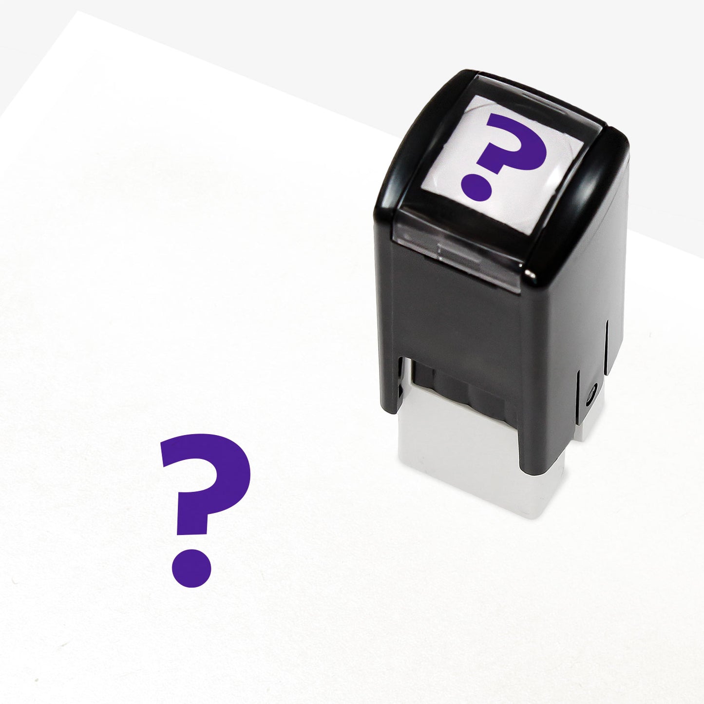 A 10mm self-inking stamp with a solid purple question mark central to the design