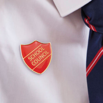 Image of an enamel shield badge with the wording school council the badge is red 
