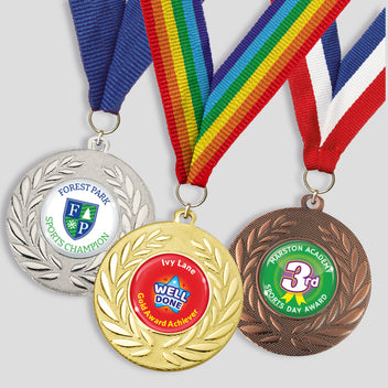Three medals with ribbons on a plain background