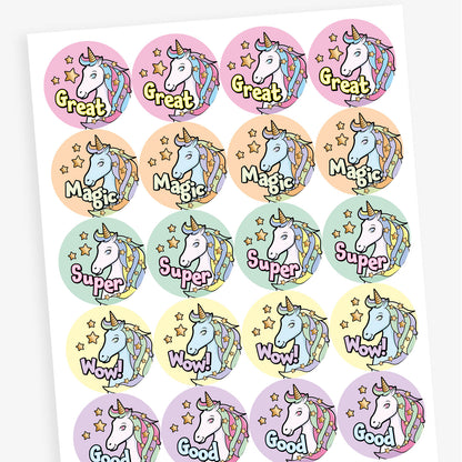 Sheet of 20 round pastel-coloured stickers, each 32mm in diameter, featuring a white unicorn with a rainbow mane and horn, surrounded by stars. Each sticker displays one of five motivational words: 'Great', 'Magic', 'Super', 'Wow!', or 'Good'.