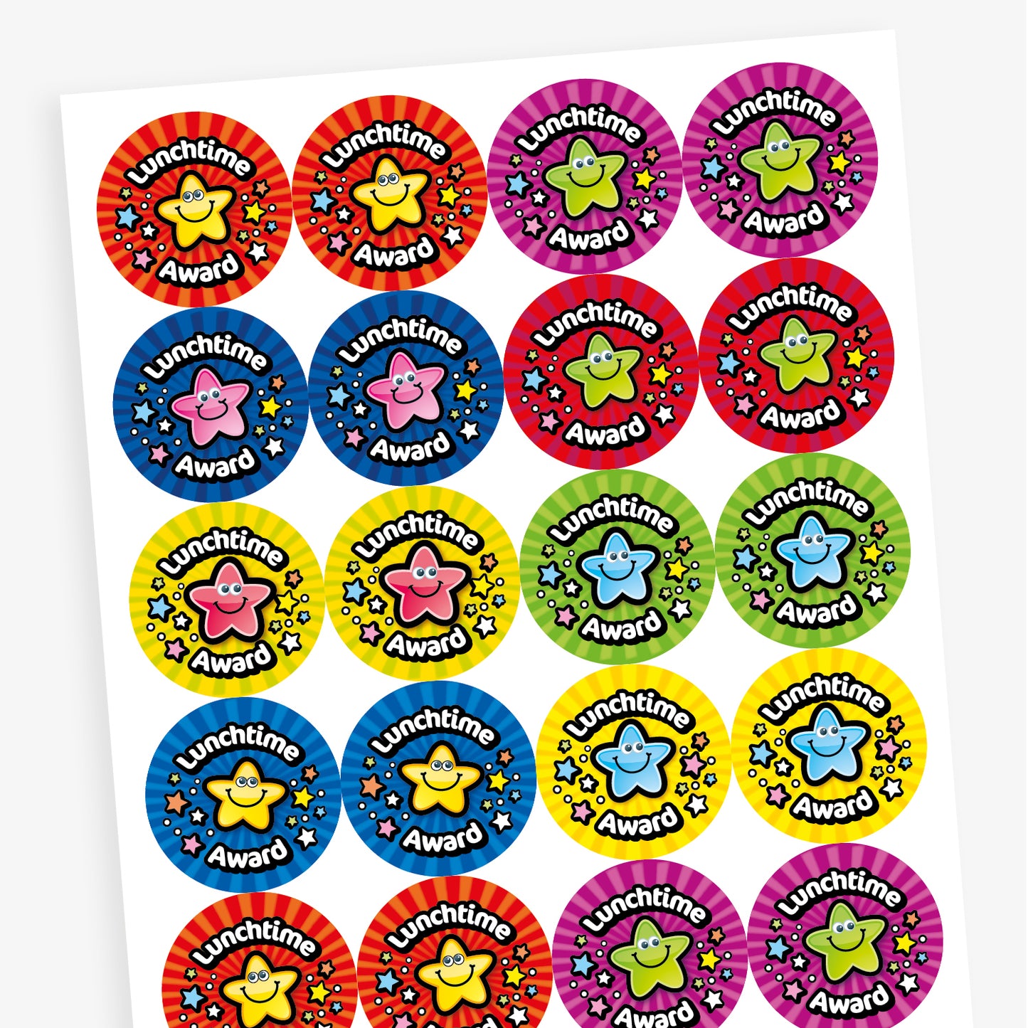 A sheet of brightly coloured circular stickers with the phrase 'Lunchtime Award' in bold white text on a black curved banner. Each sticker features a smiling cartoon star character in the centre, surrounded by colourful stars. Background colours include red, purple, blue, yellow, and green, with vibrant radial patterns that create a cheerful and eye-catching effect.