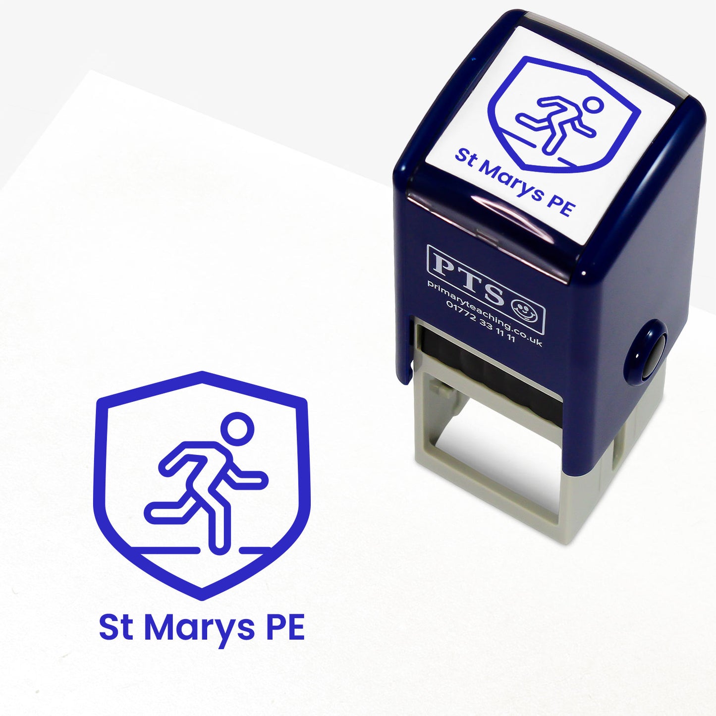 A stamper shown next to a sample stamped image on a white background. The stamp has a blue outline of a running figure inside a shield shape, with placeholder text 'St Mary's PE' on the top panel and below the stamp print.