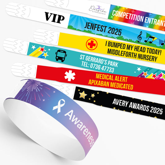Collection of colourful wristbands with various text and designs on a white background showing a range of personalisation options.
