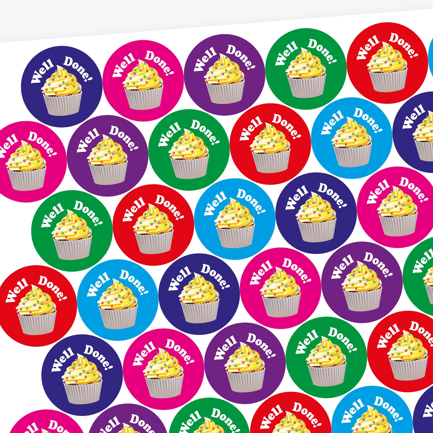 A sheet of circular, vanilla scented stickers, each with a cupcake with vanilla frosting as the main image below the phrase 'Well Done!'.  Colourful backgrounds of blue, magenta and green are shown.