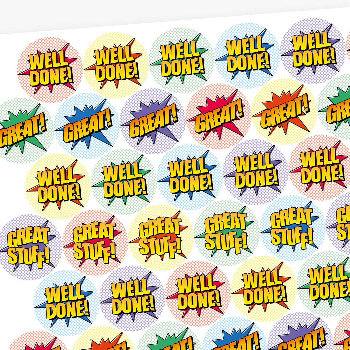Overview of a sheet of sherbet scented colourful round stickers with comic book-style designs. Stickers feature bold text such as 'WELL DONE!' and 'GREAT!' in yellow with black outlines, set against vibrant starburst shapes in red, green, blue, and other colours.