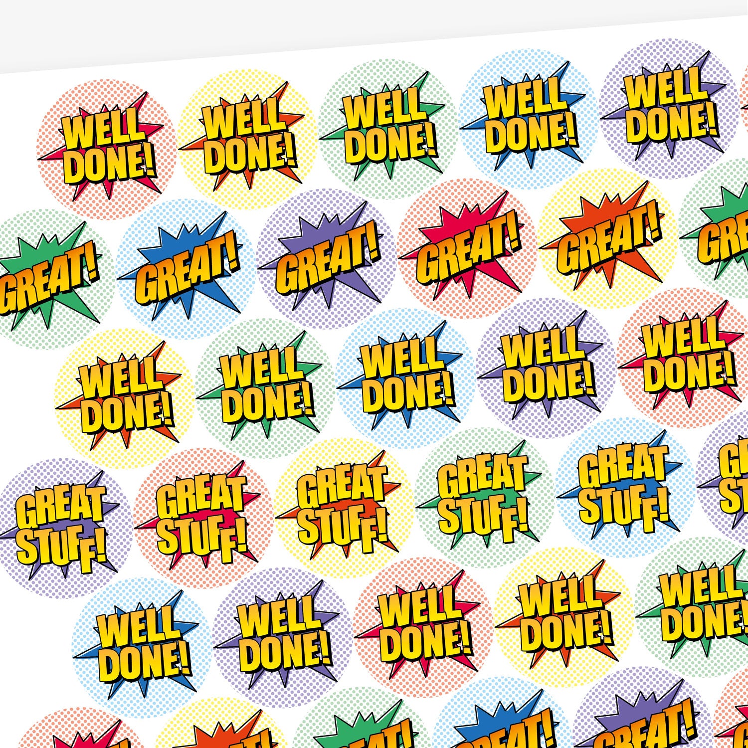Overview of a sheet of sherbet scented colourful round stickers with comic book-style designs. Stickers feature bold text such as 'WELL DONE!' and 'GREAT!' in yellow with black outlines, set against vibrant starburst shapes in red, green, blue, and other colours.