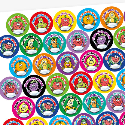 A fruity scented sheet of colourful circular 'Clean Plate Award' stickers featuring smiling cartoon fruits and vegetables, such as an apple, pear, corn, and pineapple, each holding a knife and fork with an empty plate. Background colours include green, red, orange, and purple.
