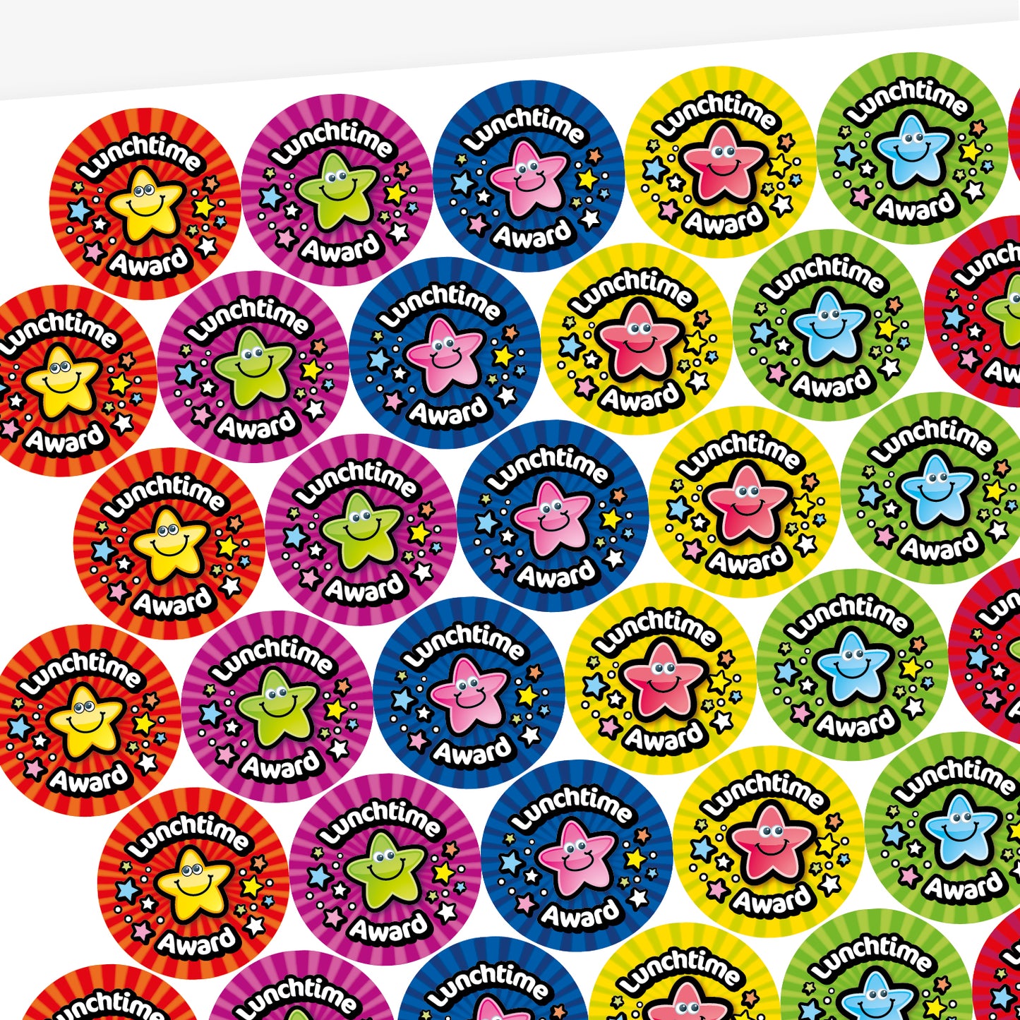 A sheet of colourful, fruit scented, circular 'Lunchtime Award' stickers featuring smiling cartoon stars in different colours, including yellow, red, blue, green, and pink. Each sticker has a striped or patterned background with scattered stars.