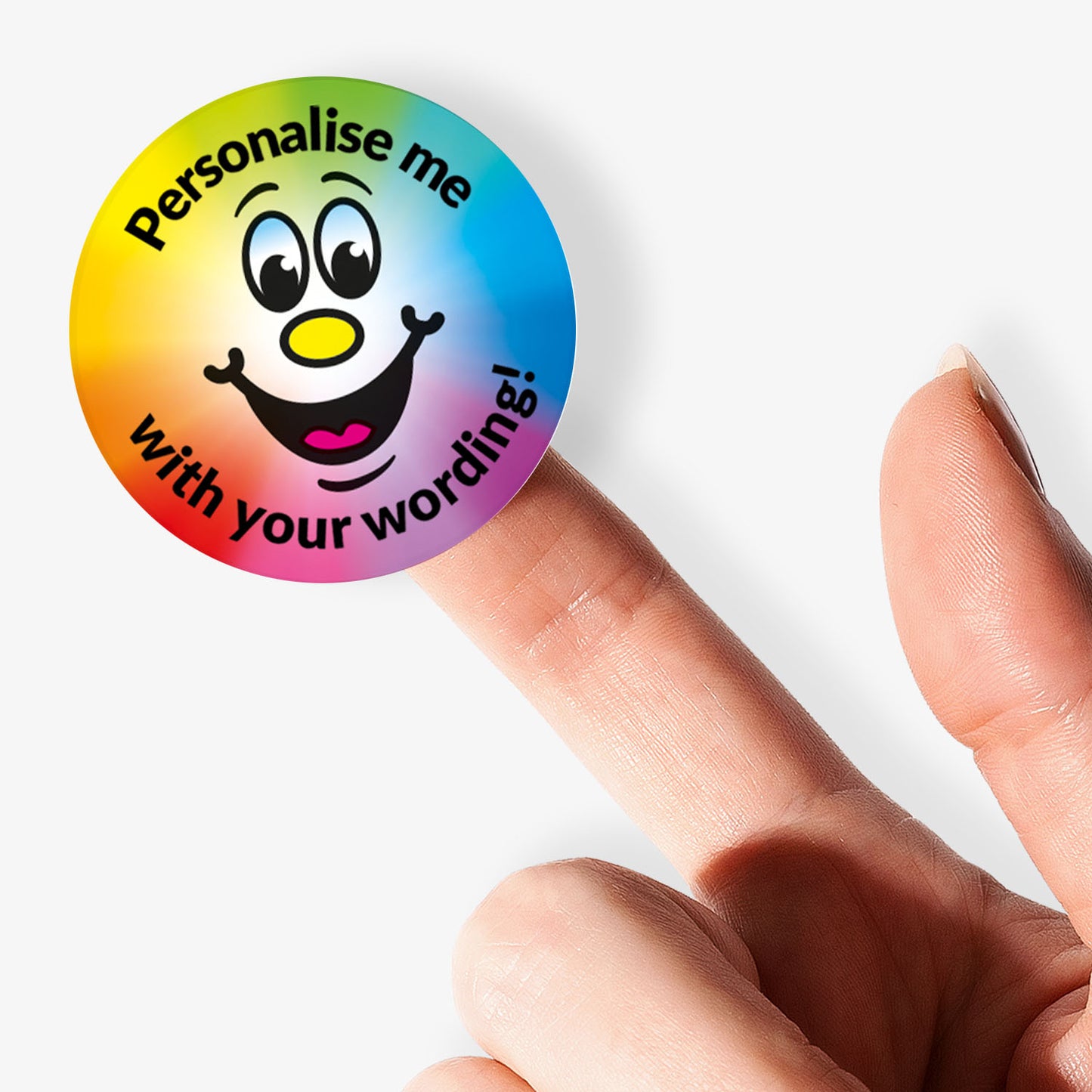 Colorful round stickers with smiling faces and text 'Personalise me with your wording!' held by a finger.