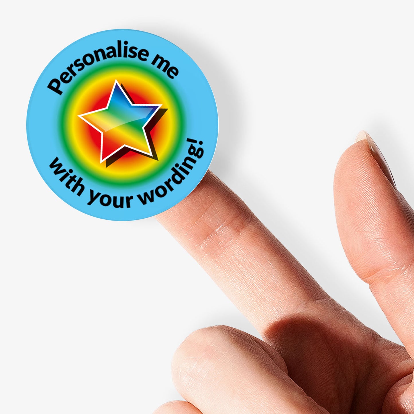 Colorful star-shaped badge with text 'Personalise me with your wording!' held by a finger on a white background.
