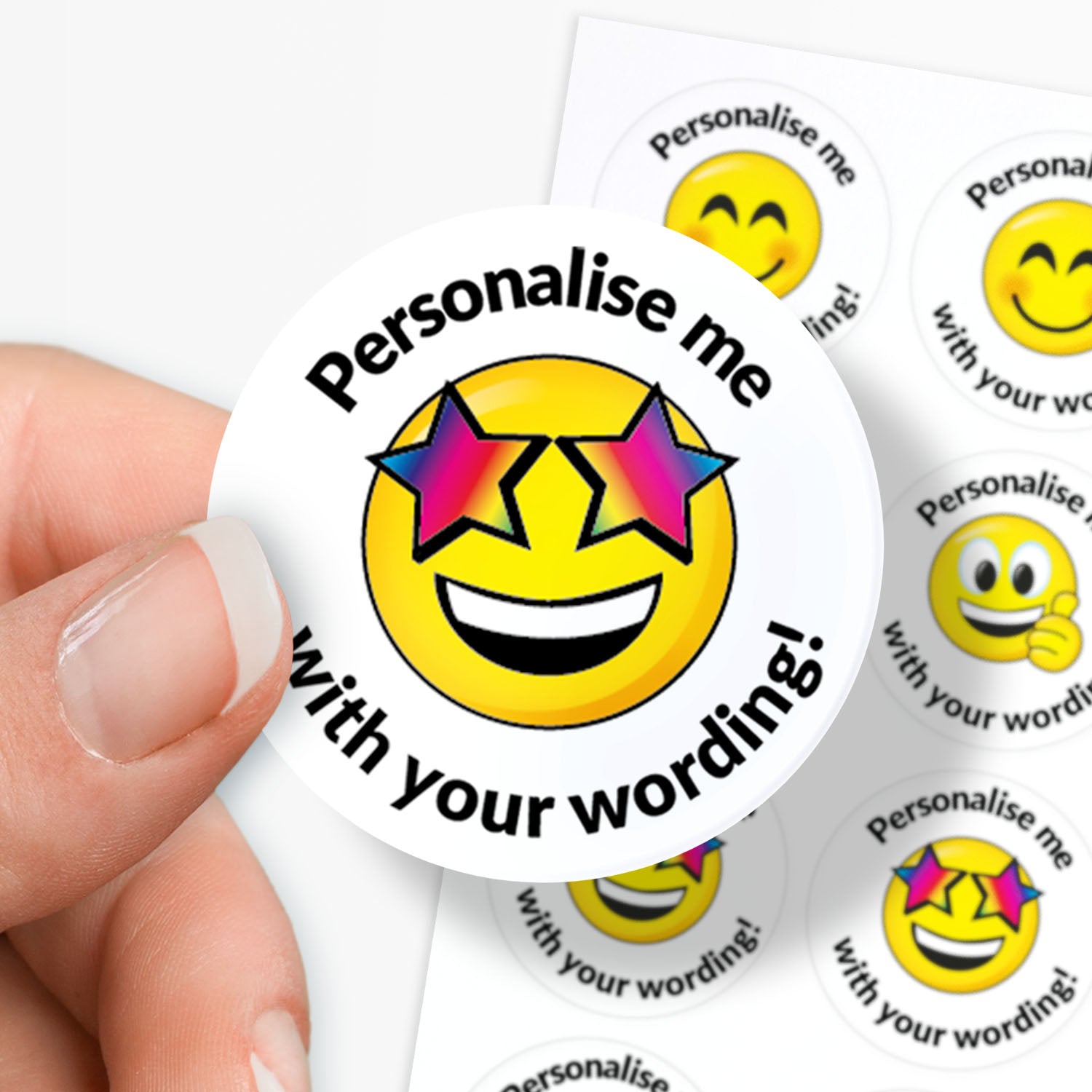 Smiley face sticker with 'Personalise me with your wording!' text held by a hand.