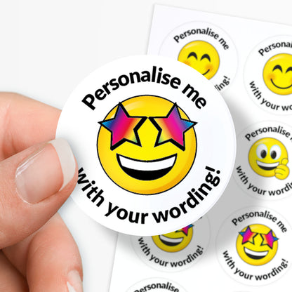 Smiley face sticker with 'Personalise me with your wording!' text held by a hand.