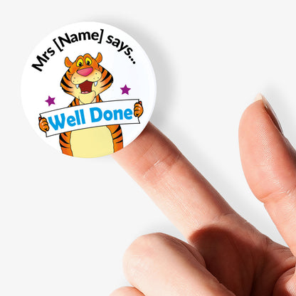 Sticker with a tiger character and 'Well Done' text held by one finger on a white background