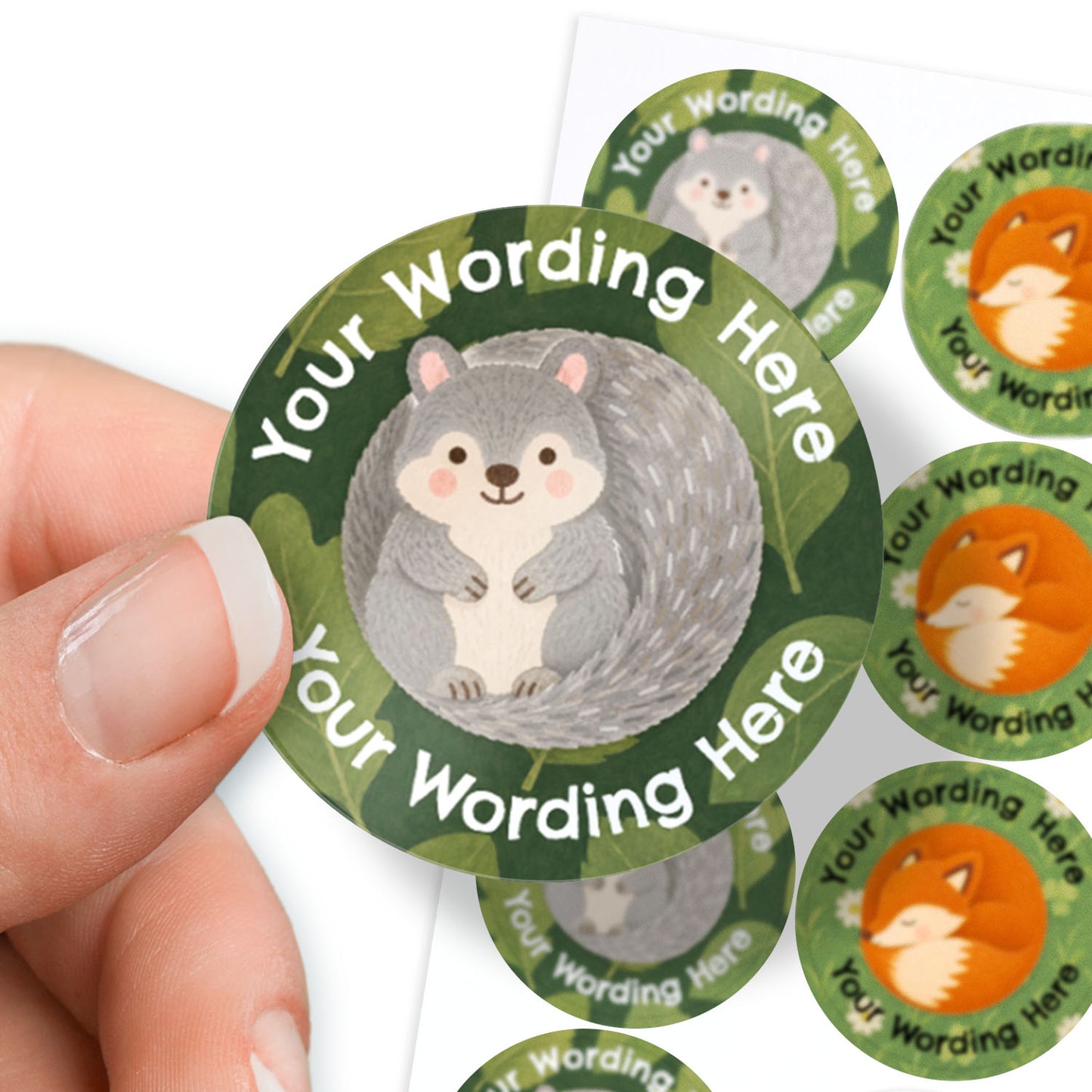 Circular custom sticker featuring a grey squirrel with the text 'Your Wording Here' on a green leaf-patterned background. Several other nature-themed stickers are visible behind it.