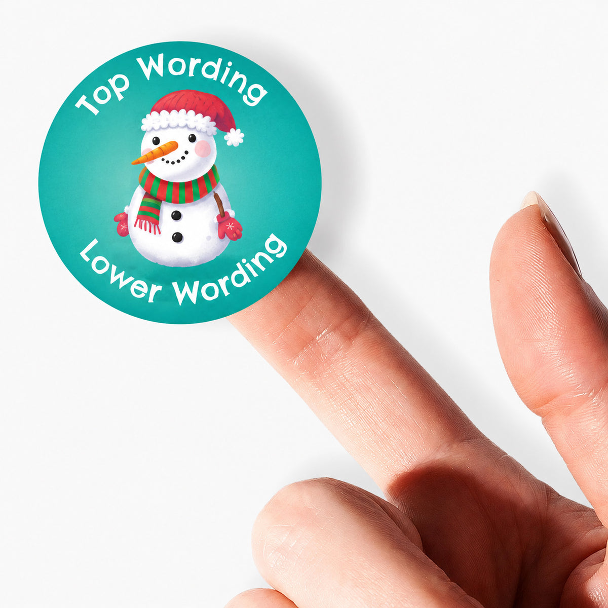 Personalised Christmas snowman sticker balanced on fingertip