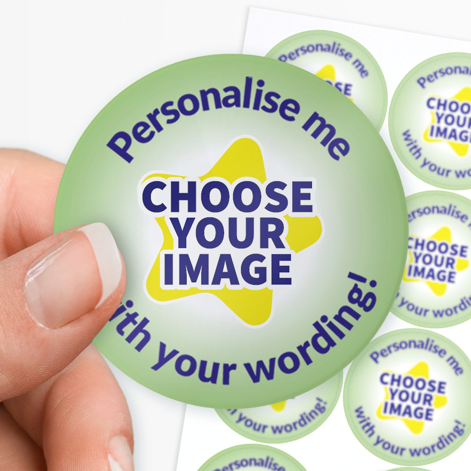Colorful sticker with text 'Personalise me, choose your image with your wording!' held by hand with sheet of stickers in the background.