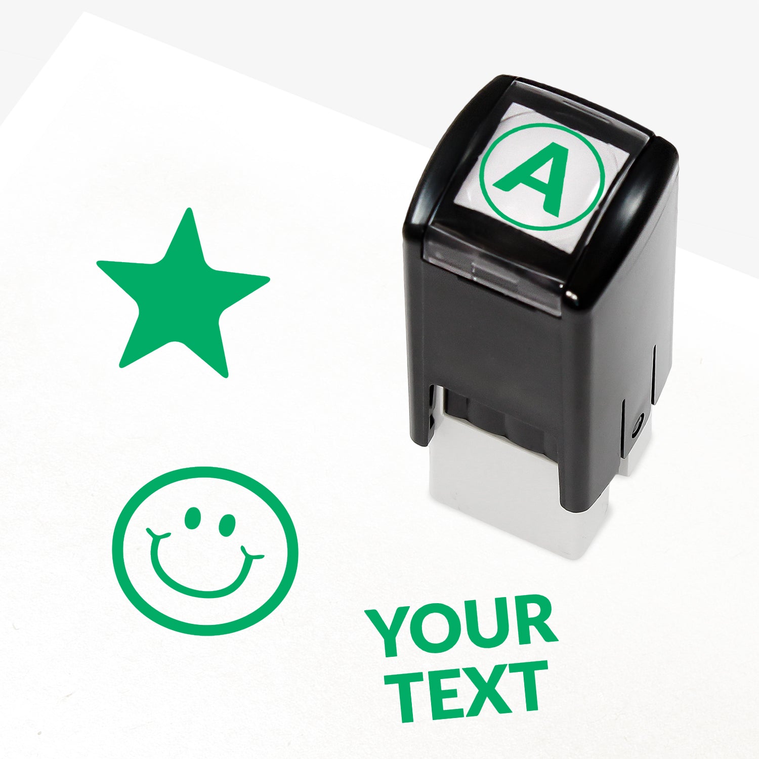 Customisable red self-inking 10mm stamper with the placeholder text 'YOUR TEXT' in bold red, alongside alternative options for icons such as smiling face or star, indicating space for a personalised image or message.
