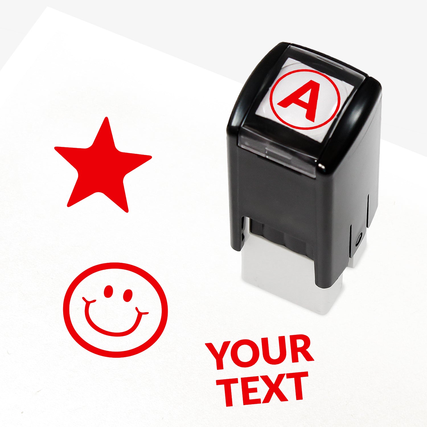 Customisable black self-inking 10mm stamper with the placeholder text 'YOUR TEXT' in bold black, alongside alternative options for icons such as smiling face or star, indicating space for a personalised image or message.