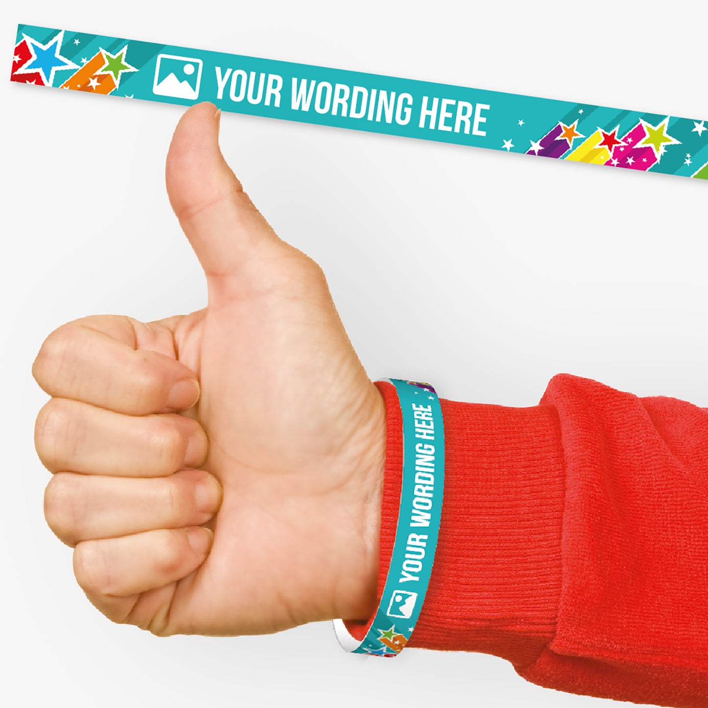 A customisable wristband with a cyan background with shooting stars of vibrant colours.  The centre is displaying the placeholder text 'YOUR WORDING HERE' alongside an 'choose image' icon. Also shown on a wrist of a person in a red jumper giving a thumbs up signal.