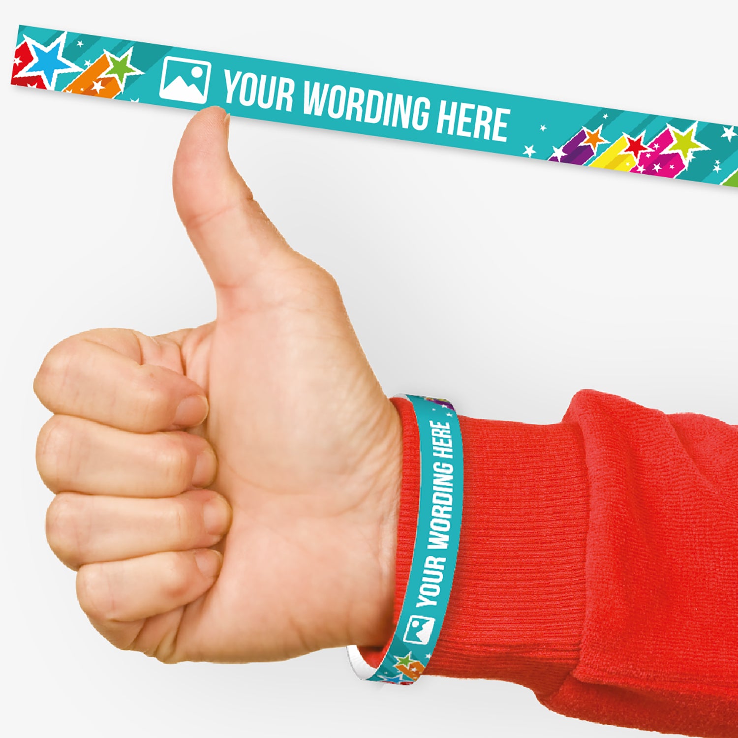 A customisable wristband with a cyan background with shooting stars of vibrant colours.  The centre is displaying the placeholder text 'YOUR WORDING HERE' alongside an 'choose image' icon. Also shown on a wrist of a person in a red jumper giving a thumbs up signal.