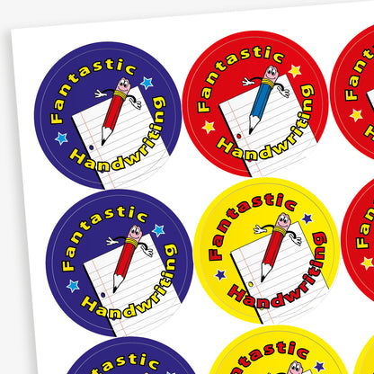 A sheet of circular reward stickers for children, each with a colourful background and the phrase 'Fantastic Handwriting'. Each sticker features a smiling cartoon pencil with arms and legs, positioned over a sheet of lined paper. The backgrounds are in different colours: blue, red, yellow, and purple.