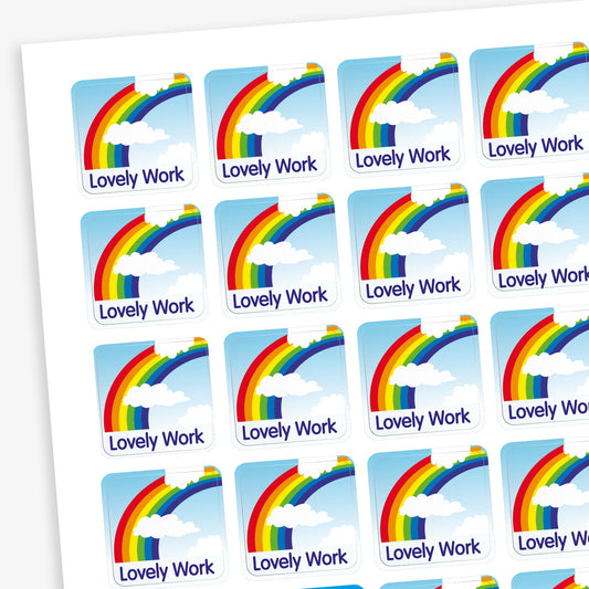 A sheet of 140 square 16mm reward stickers, each featuring the phrase 'Lovely Work' in bold text, set against a sky background with a vibrant coloured rainbow.