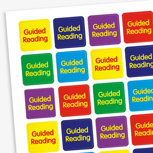 A sheet of 140 square 16mm reward stickers, each featuring the phrase 'Guided Reading' in bold yellow text, set against vibrant backgrounds of Red, Purple, Cyan, Dark Blue and Green.