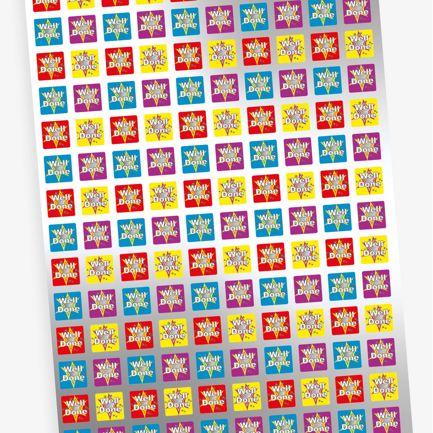 A sheet of colourful square reward stickers featuring the phrase 'Well Done' in white text with a starburst background. The stickers come in red, yellow, blue, and purple, each with a decorative star and confetti design.