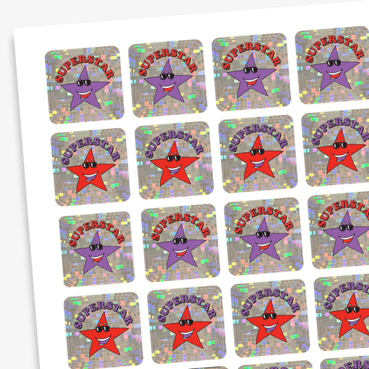 A sheet of square holographic 'Superstar' stickers featuring alternating purple and red cartoon stars wearing sunglasses. Each star has the word 'SUPERSTAR' in a curved red or blue font above it, set against a sparkly silver background.