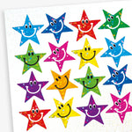 A sheet of colourful star shaped smiley face stickers with a holographic finish. Each sticker features a cheerful smiling face in different colours including blue, green, red, silver, purple and yellow.