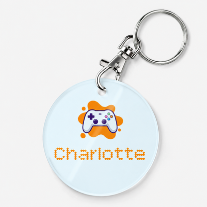 A personalized acrylic bag tag featuring a gaming controller and example text 'Charlotte'.