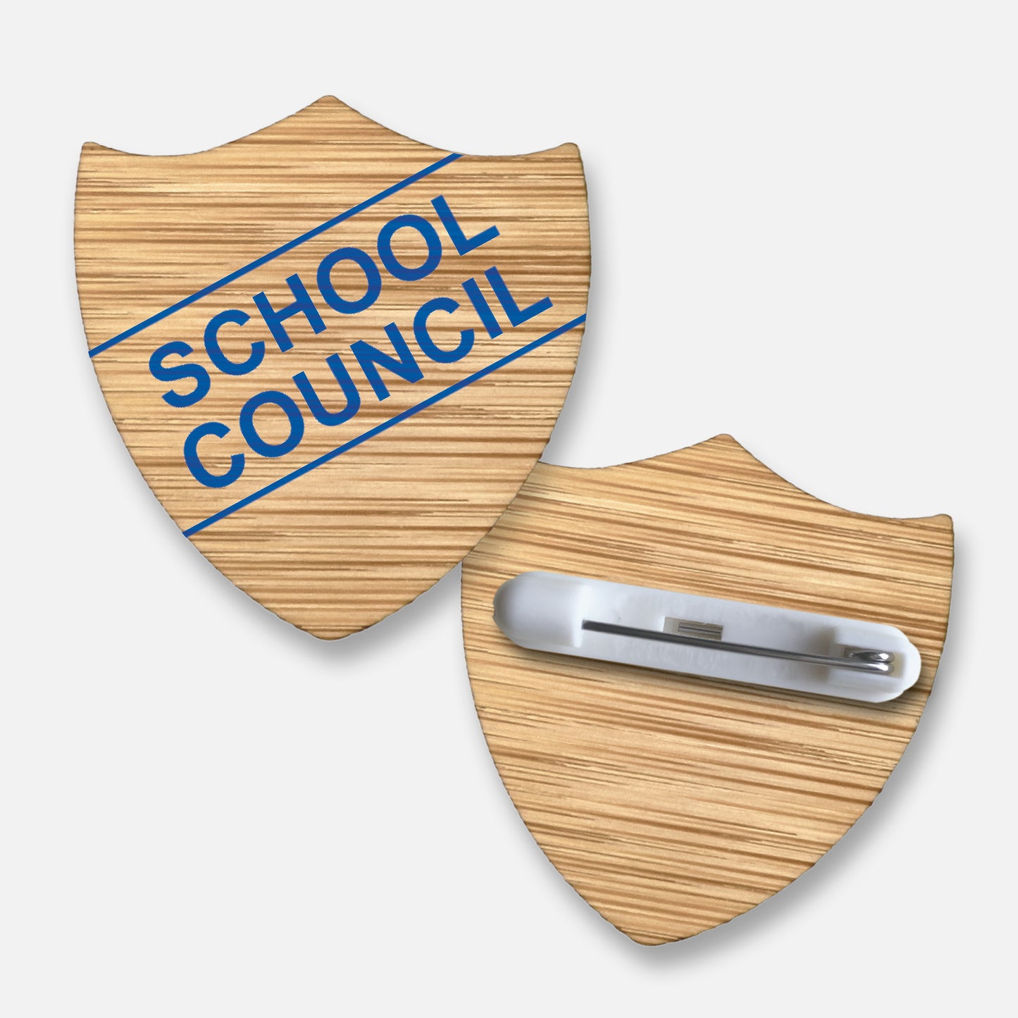 Bamboo shield-shaped badge with natural wood grain finish.  Features a diagonal double line of text 'SCHOOL COUNCIL' in blue print; measures approximately 34mm x 36mm and includes a pin fastening on the reverse.