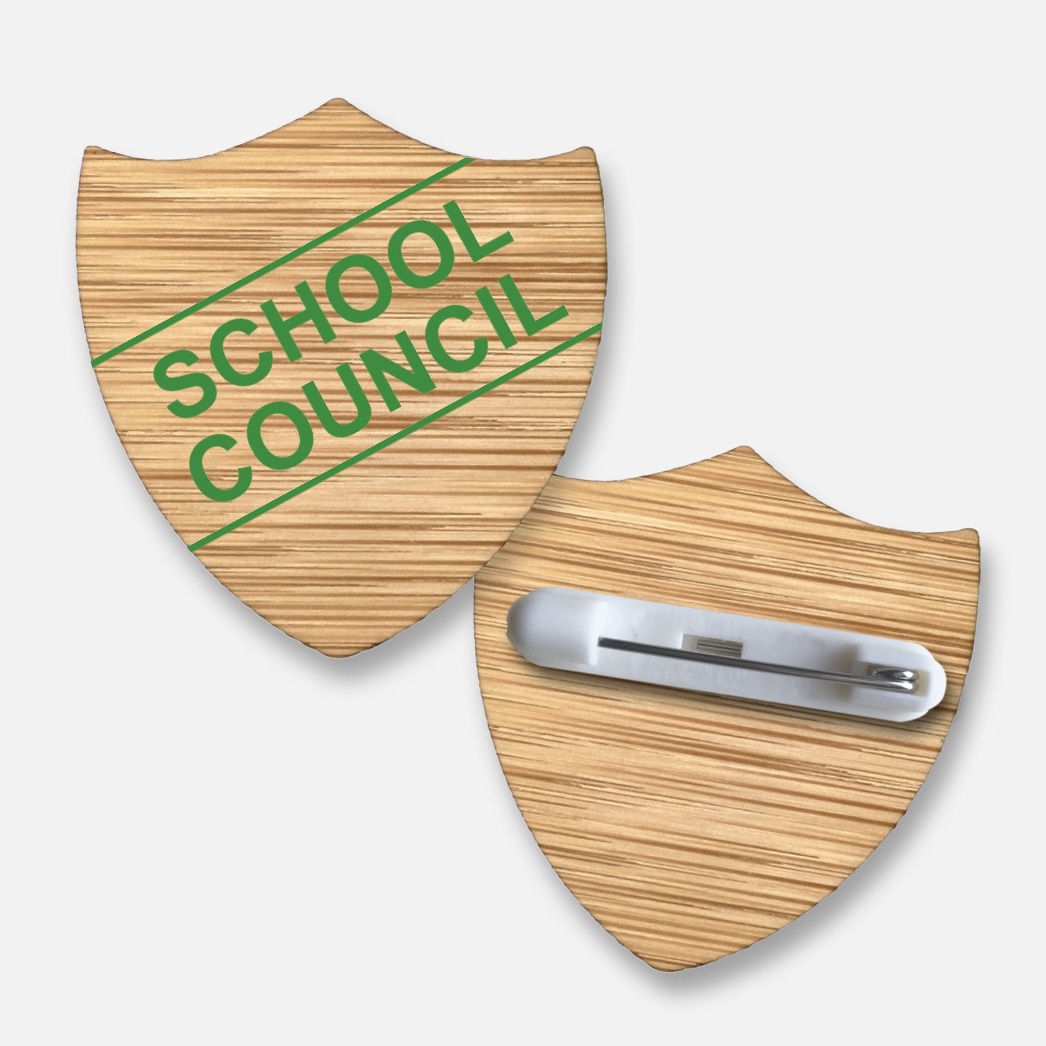 Bamboo shield-shaped badge with natural wood grain finish.  Features a diagonal double line of text 'SCHOOL COUNCIL' in green print; measures approximately 34mm x 36mm and includes a pin fastening on the reverse.