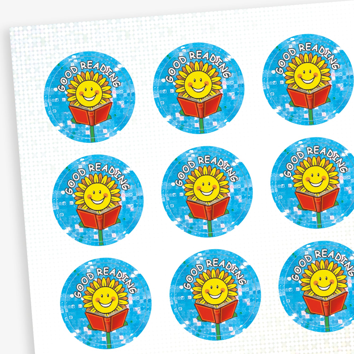 A sheet of circular 'Good Reading' reward stickers with a sparkly blue background. Each sticker features a smiling sun character holding an open red book, with the words 'GOOD READING' in white uppercase text above the illustration.