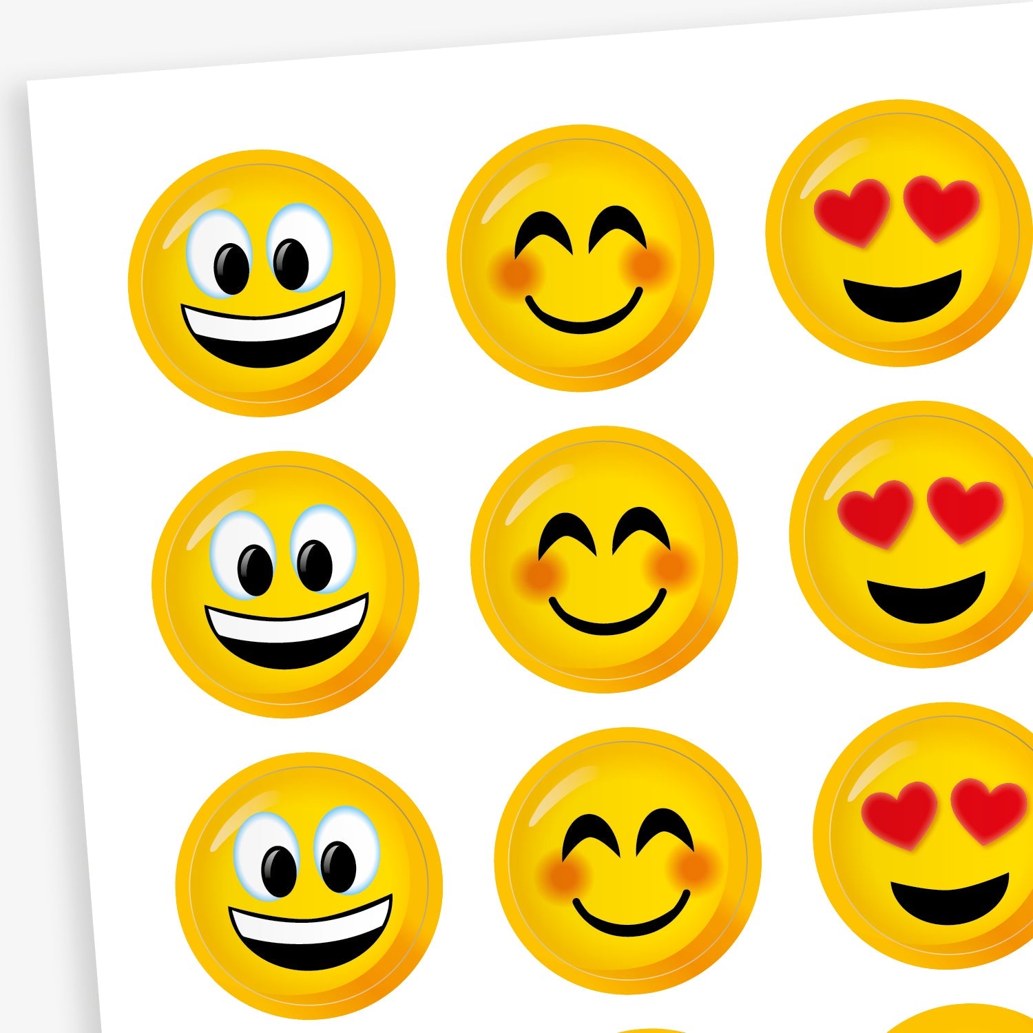 A sheet of circular emoji-style stickers with bright yellow faces. Designs include smiling faces with open mouths, closed-eye smiles with rosy cheeks, and faces with heart-shaped eyes. These cheerful expressions are used to convey positivity, happiness, and affection.